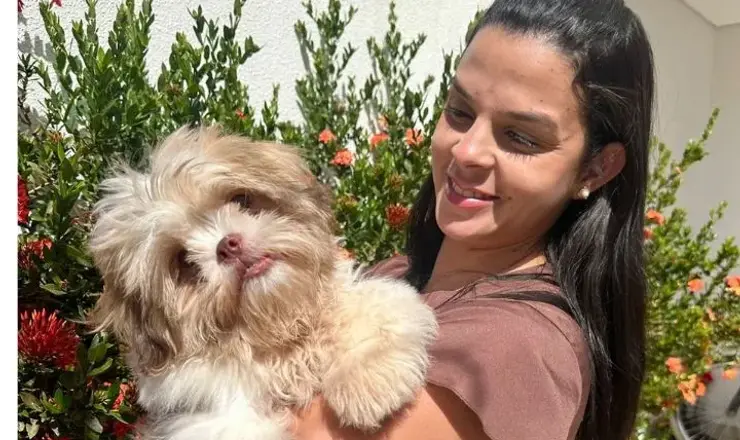Veterinária da Unnavet com um shih-tzu no colo